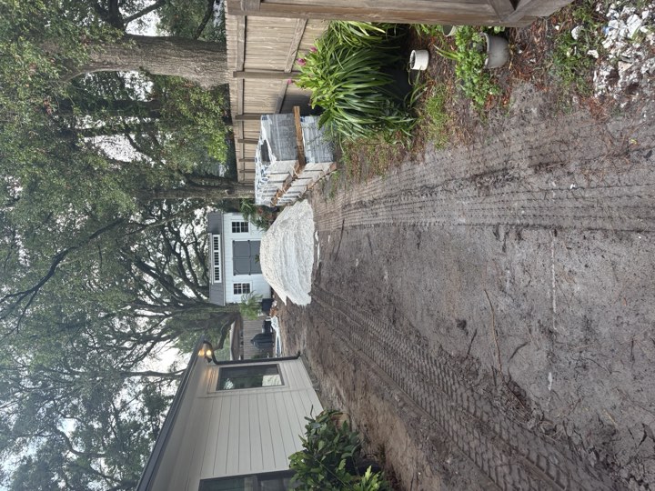 Fill dirt delivered and dumped at a customer's house in a tight side yard